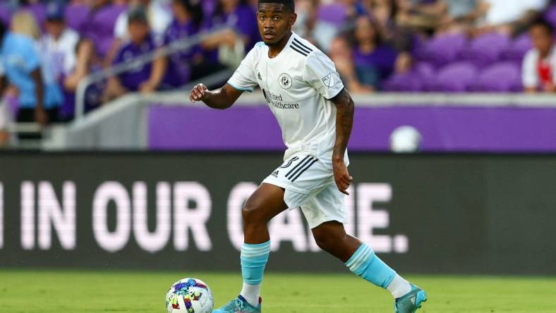 Aug 6, 2022; Orlando, Florida, USA;  New England Revolution midfielder Maciel (13) controls the ball against Orlando City in the first half at Exploria Stadium. Mandatory Credit: Nathan Ray Seebeck-USA TODAY Sports