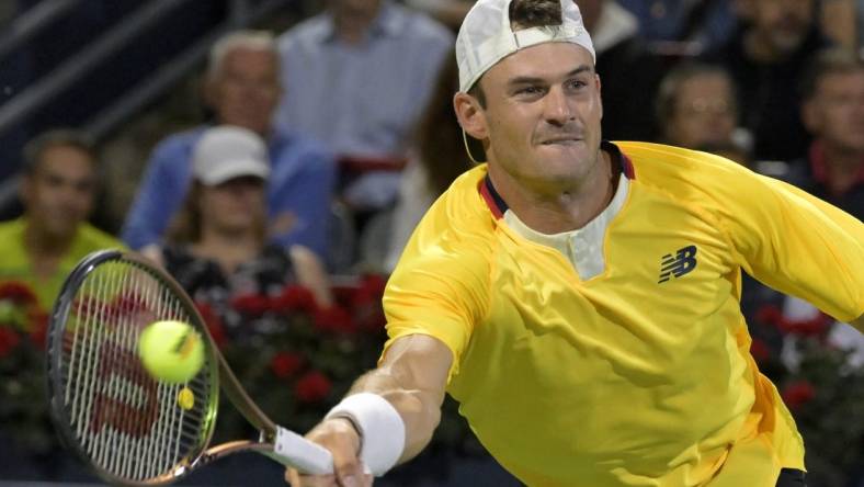 Aug 12, 2022; Montreal, QC, Canada; Tommy Paul (USA) hits a forehand against Daniel Evans (GBR) (not pictured) in quarterfinal play in the National Bank Open at IGA Stadium. Mandatory Credit: Eric Bolte-USA TODAY Sports