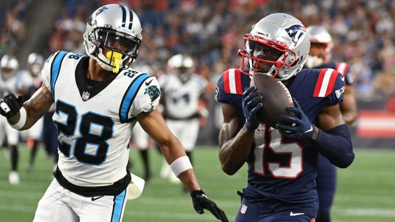 Aug 19, 2022; Foxborough, Massachusetts, USA; New England Patriots wide receiver Nelson Agholor (15) makes a catch with pressure from Carolina Panthers cornerback Keith Taylor Jr. (28) during the first half of a preseason game at Gillette Stadium. Mandatory Credit: Eric Canha-USA TODAY Sports