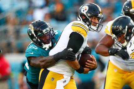 Aug 20, 2022; Jacksonville, Florida, USA;  Pittsburgh Steelers quarterback Mitch Trubisky (10) is pressured by Jacksonville Jaguars linebacker K'Lavon Chaisson (45) in the first quarter at TIAA Bank Field. Mandatory Credit: Nathan Ray Seebeck-USA TODAY Sports