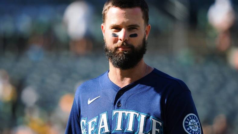 Aug 20, 2022; Oakland, California, USA; Seattle Mariners left fielder Jesse Winker (27) returns to the dugout after the top of the third inning against the Oakland Athletics at RingCentral Coliseum. Mandatory Credit: Kelley L Cox-USA TODAY Sports