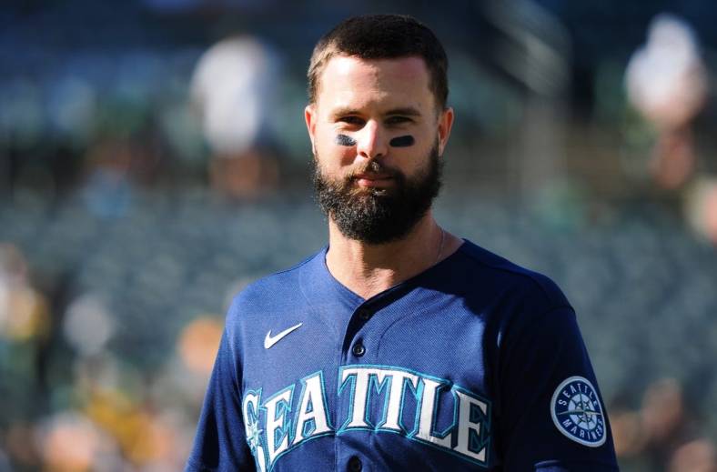Aug 20, 2022; Oakland, California, USA; Seattle Mariners left fielder Jesse Winker (27) returns to the dugout after the top of the third inning against the Oakland Athletics at RingCentral Coliseum. Mandatory Credit: Kelley L Cox-USA TODAY Sports