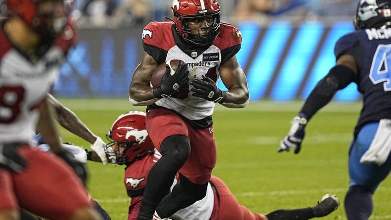 Aug 20, 2022; Toronto, Ontario, CAN; Calgary Stampeders running back Dedrick Mills (34) runs the football against the Toronto Argonauts during the second half at BMO Field. Mandatory Credit: John E. Sokolowski-USA TODAY Sports