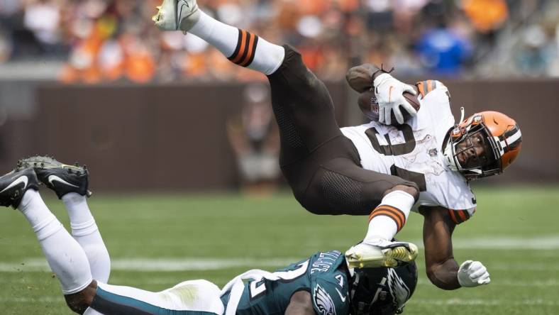 Aug 21, 2022; Cleveland, Ohio, USA; Cleveland Browns running back Jerome Ford (34) flies over Philadelphia Eagles safety K'Von Wallace (42) following his tackle during the second quarter at FirstEnergy Stadium. Mandatory Credit: Scott Galvin-USA TODAY Sports