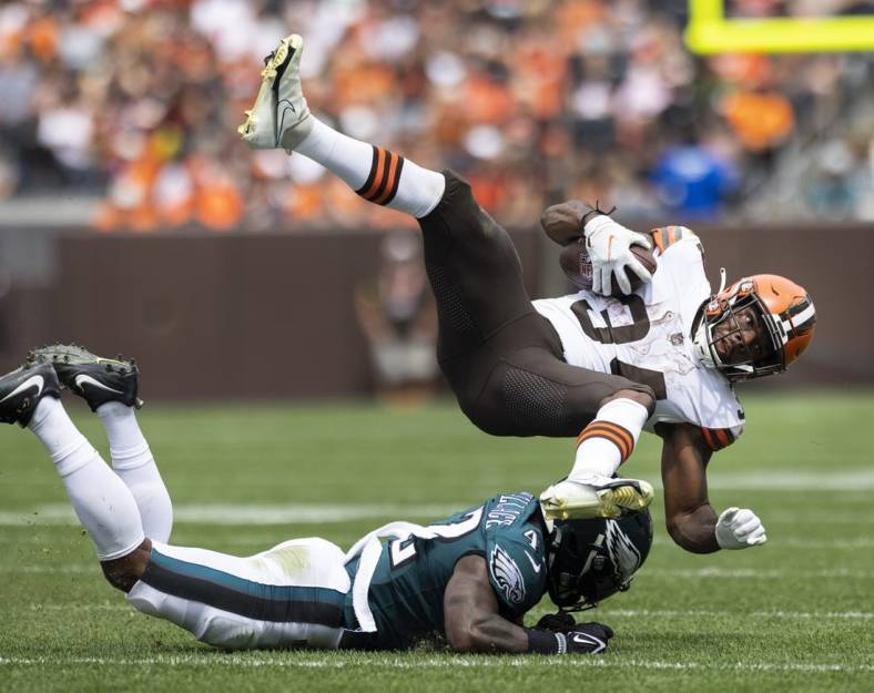 Aug 21, 2022; Cleveland, Ohio, USA; Cleveland Browns running back Jerome Ford (34) flies over Philadelphia Eagles safety K'Von Wallace (42) following his tackle during the second quarter at FirstEnergy Stadium. Mandatory Credit: Scott Galvin-USA TODAY Sports