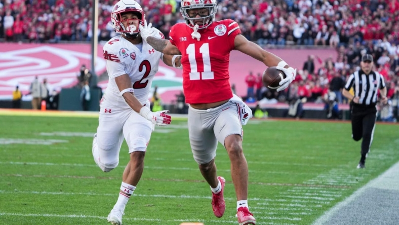 Ohio State wide receiver Jaxon Smith-Njigba fends off Utah cornerback Micah Bernard as he races to the end zone for a touchdown during the second quarter of the 2022 Rose Bowl in Pasadena, Calif.

2022-08-23-smith-njigba