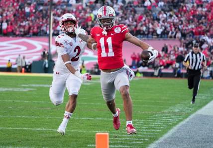 Ohio State wide receiver Jaxon Smith-Njigba fends off Utah cornerback Micah Bernard as he races to the end zone for a touchdown during the second quarter of the 2022 Rose Bowl in Pasadena, Calif.

2022-08-23-smith-njigba