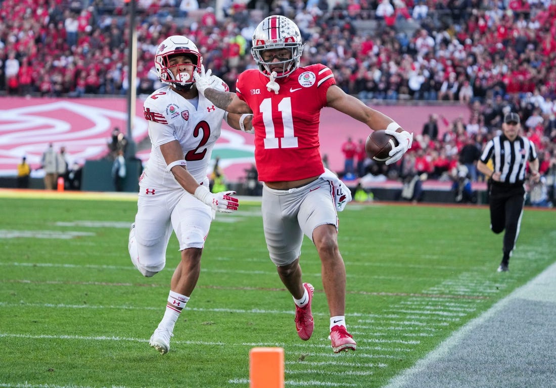 Ohio State wide receiver Jaxon Smith-Njigba fends off Utah cornerback Micah Bernard as he races to the end zone for a touchdown during the second quarter of the 2022 Rose Bowl in Pasadena, Calif.

2022-08-23-smith-njigba