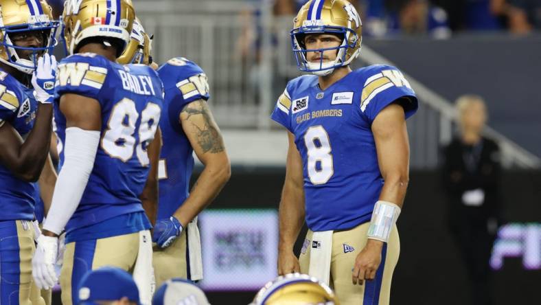 Aug 25, 2022; Winnipeg, Manitoba, CAN;  Winnipeg Blue Bombers quarterback Zach Collaros (8) reacts to an injured teammate during the second half against the Calgary Stampeders at IG Field. Winnipeg wins 31-29. Mandatory Credit: Bruce Fedyck-USA TODAY Sports