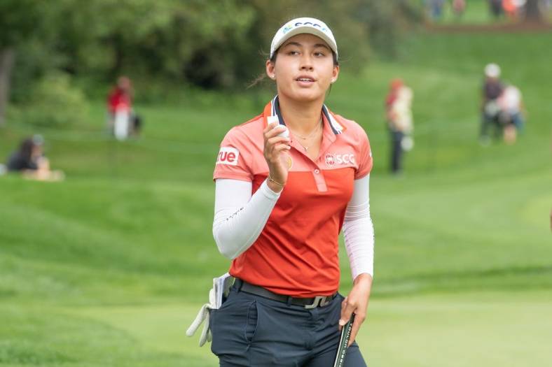 Aug 26, 2022; Ottawa, Ontario, CAN; Atthaya Thitikul from Thailand completes her 18th hole during the second round of the CP Women's Open golf tournament. Mandatory Credit: Marc DesRosiers-USA TODAY Sports