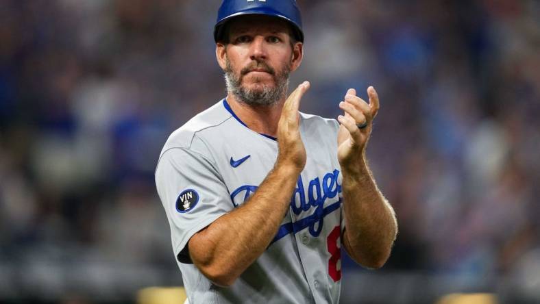 Aug 12, 2022; Kansas City, Missouri, USA; Los Angeles Dodgers first base coach Clayton McCullough (86) takes the field during the fifth inning against the Kansas City Royals at Kauffman Stadium. Mandatory Credit: Jay Biggerstaff-USA TODAY Sports