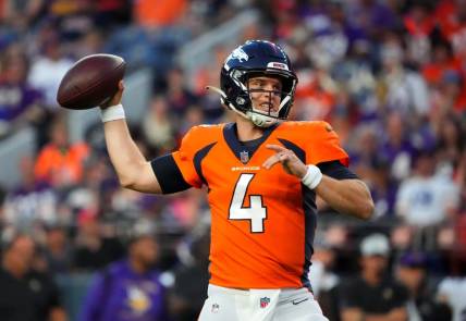 Aug 27, 2022; Denver, Colorado, USA; Denver Broncos quarterback Brett Rypien (4) prepares to pass the ball the ball in the first quarter against the Minnesota Vikings at Empower Field at Mile High. Mandatory Credit: Ron Chenoy-USA TODAY Sports
