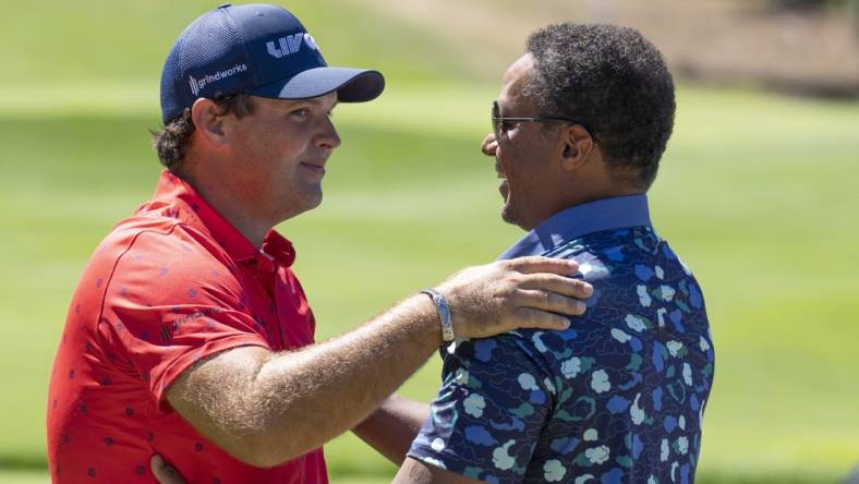 Sep 2, 2022; Boston, Massachusetts, USA; Patrick Reed (left) is greeted by LIV Golf Managing Director Majed Al Sorour before the start of the first round of the LIV Golf tournament  at The International. Mandatory Credit: Richard Cashin-USA TODAY Sports