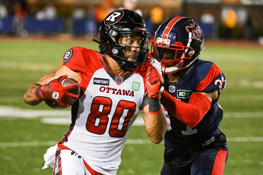 Sep 2, 2022; Montreal, Quebec, CAN; Montreal Alouettes defensive back Wesley Sutton (37) tackles Ottawa Redblacks wide receiver Nate Behar (80) during the fourth quarter at Percival Molson Memorial Stadium. Mandatory Credit: David Kirouac-USA TODAY Sports