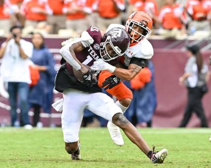 Sep 3, 2022; College Station, Texas, USA;  Texas A&M Aggies wide receiver Chris Marshall (10) is tackled by Sam Houston State Bearkats defensive back Isaiah Downes (4) during the second half at Kyle Field. Mandatory Credit: Maria Lysaker-USA TODAY Sports