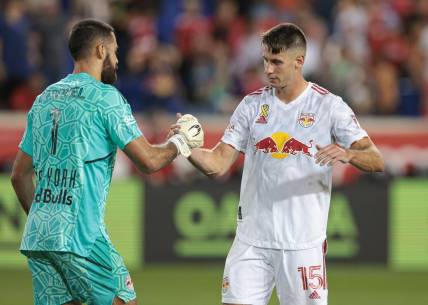 Sep 10, 2022; Harrison, New Jersey, USA;  New York Red Bulls goalkeeper Carlos Miguel Coronel (1) celebrates with defender Sean Nealis (15) after defeating New England Revolution at Red Bull Arena. Mandatory Credit: Vincent Carchietta-USA TODAY Sports