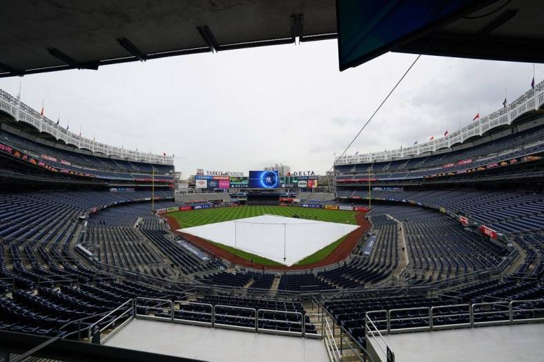 Sep 11, 2022; Bronx, New York, USA;  The tarp is on the field due to rain and a delayed start prior to the game between the Tampa Bay Rays and New York Yankees at Yankee Stadium. Mandatory Credit: Gregory Fisher-USA TODAY Sports