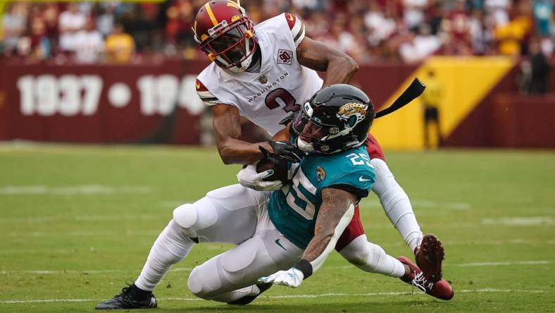 Sep 11, 2022; Landover, Maryland, USA; Washington Commanders cornerback William Jackson III (3) tackles Jacksonville Jaguars running back James Robinson (25) during the first half at FedExField. Mandatory Credit: Scott Taetsch-USA TODAY Sports