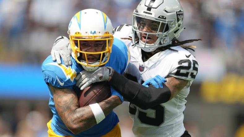 Sep 11, 2022; Inglewood, California, USA; Los Angeles Chargers wide receiver Keenan Allen (13) and Las Vegas Raiders safety Tre'von Moehrig (25) in the first half at SoFi Stadium. Mandatory Credit: Kirby Lee-USA TODAY Sports