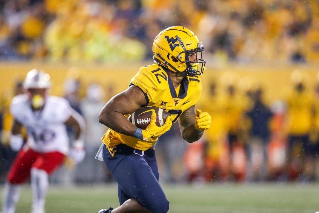 Sep 10, 2022; Morgantown, West Virginia, USA; West Virginia Mountaineers running back CJ Donaldson (12) runs the ball during the third quarter against the Kansas Jayhawks at Mountaineer Field at Milan Puskar Stadium. Mandatory Credit: Ben Queen-USA TODAY Sports