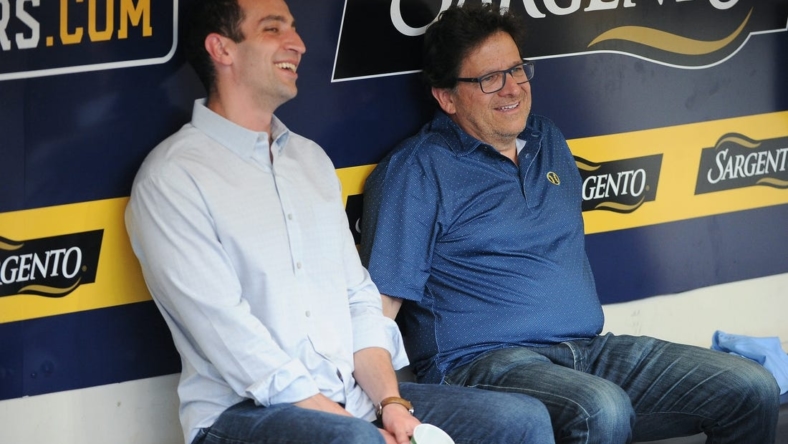 Sep 17, 2022; Milwaukee, Wisconsin, USA;  Milwaukee Brewers Baseball Operations and General Manager David Stearns and Milwaukee Brewers Owner Mark Attanasio share a laugh while talking in the dugout before their game against the New York Yankees at American Family Field. Mandatory Credit: Michael McLoone-USA TODAY Sports