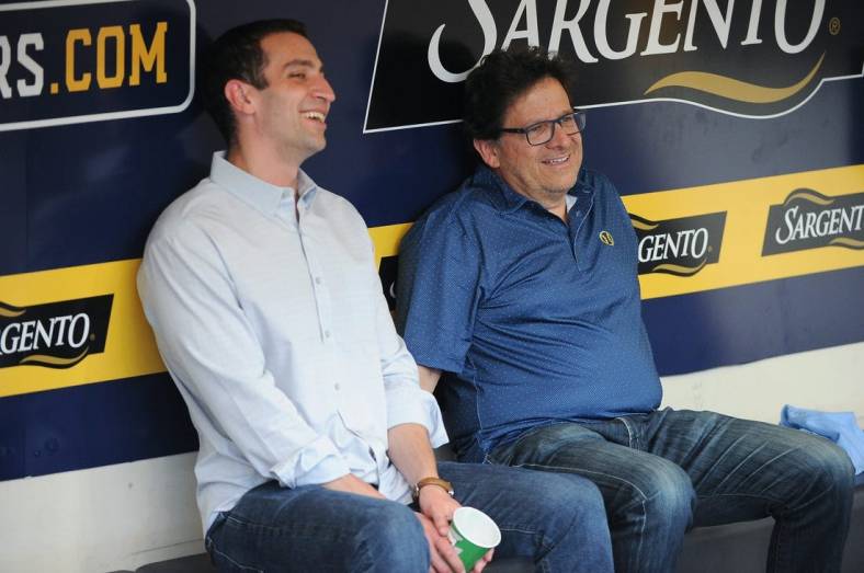 Sep 17, 2022; Milwaukee, Wisconsin, USA;  Milwaukee Brewers Baseball Operations and General Manager David Stearns and Milwaukee Brewers Owner Mark Attanasio share a laugh while talking in the dugout before their game against the New York Yankees at American Family Field. Mandatory Credit: Michael McLoone-USA TODAY Sports