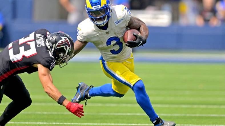 Sep 18, 2022; Inglewood, California, USA;  Los Angeles Rams running back Cam Akers (3) carries the ball for a first down before he is forced out of bounds by Atlanta Falcons safety Erik Harris (23) in the first half at SoFi Stadium. Mandatory Credit: Jayne Kamin-Oncea-USA TODAY Sports