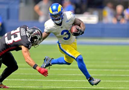 Sep 18, 2022; Inglewood, California, USA;  Los Angeles Rams running back Cam Akers (3) carries the ball for a first down before he is forced out of bounds by Atlanta Falcons safety Erik Harris (23) in the first half at SoFi Stadium. Mandatory Credit: Jayne Kamin-Oncea-USA TODAY Sports