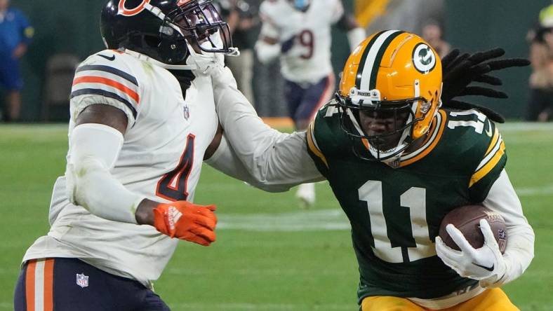 Sep 18, 2022; Green Bay, Wisconsin, USA; Green Bay Packers wide receiver Sammy Watkins (11) stiff arms Chicago Bears safety Eddie Jackson (4) while picking  up 14 yards on a reception during the fourth quarter of their game at Lambeau Field. Mandatory Credit: Mark Hoffman/Milwaukee Journal Sentinel