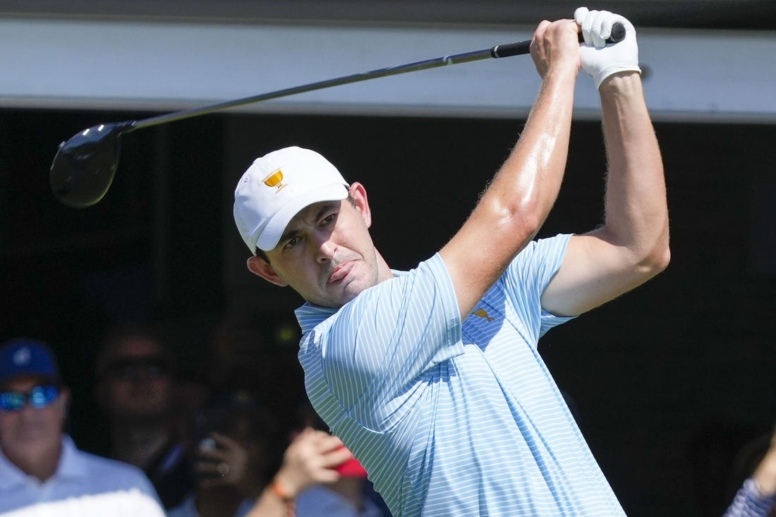 Sep 22, 2022; Charlotte, North Carolina, USA; Team USA golfer Patrick Cantlay hits his tee shot on the first hole during the foursomes match play of the Presidents Cup golf tournament at Quail Hollow Club. Mandatory Credit: Jim Dedmon-USA TODAY Sports