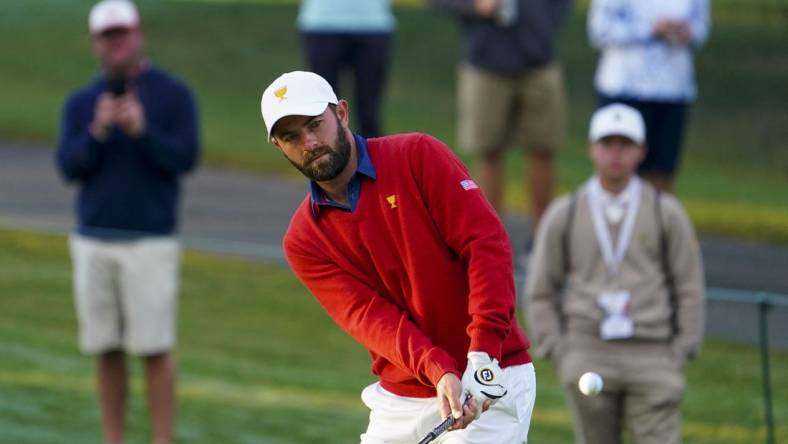 Sep 24, 2022; Charlotte, North Carolina, USA; Team USA golfer Cameron Young hits a chip shot on the third green during the foursomes match play of the Presidents Cup golf tournament at Quail Hollow Club. Mandatory Credit: Peter Casey-USA TODAY Sports