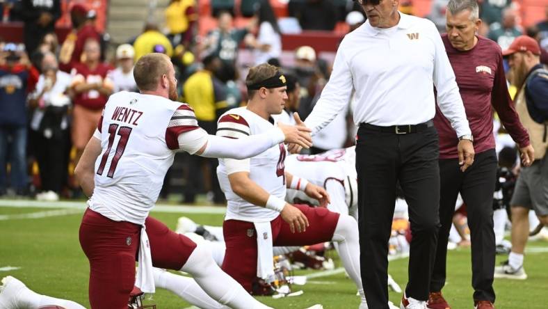 Sep 25, 2022; Landover, Maryland, USA; Washington Commanders head coach Ron Rivera greets quarterback Carson Wentz (11) before the game between the Washington Commanders and the Philadelphia Eagles at FedExField. Mandatory Credit: Brad Mills-USA TODAY Sports