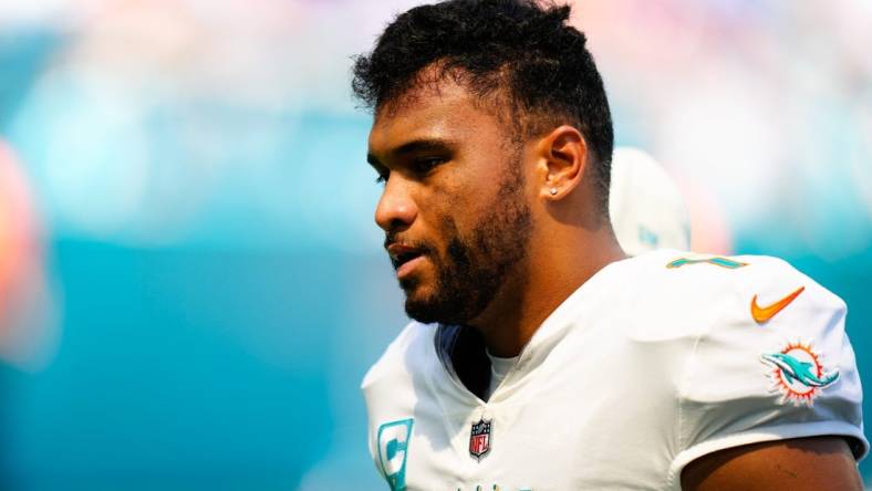 Sep 25, 2022; Miami Gardens, Florida, USA; Miami Dolphins quarterback Tua Tagovailoa (1) is helped off the field by staff after a apparent injury against the Buffalo Bills during the second quarter at Hard Rock Stadium. Mandatory Credit: Rich Storry-USA TODAY Sports