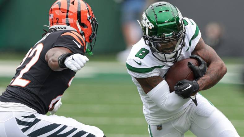 Sep 25, 2022; East Rutherford, New Jersey, USA; New York Jets wide receiver Elijah Moore (8) runs with the ball after the catch as Cincinnati Bengals cornerback Chidobe Awuzie (22) pursues during the first half at MetLife Stadium. Mandatory Credit: Vincent Carchietta-USA TODAY Sports