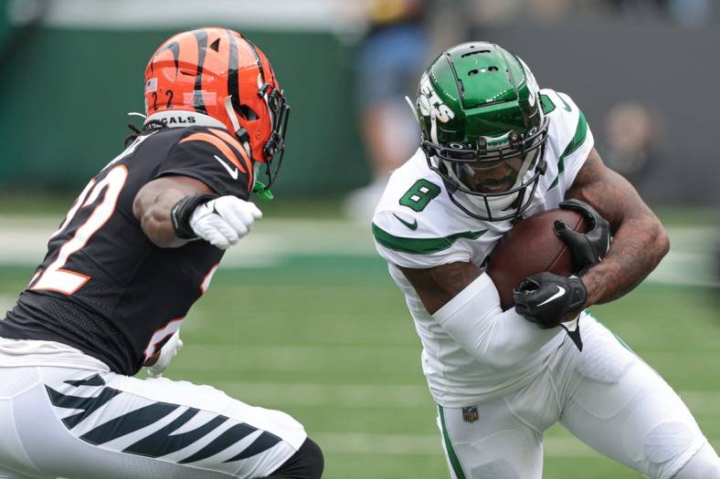 Sep 25, 2022; East Rutherford, New Jersey, USA; New York Jets wide receiver Elijah Moore (8) runs with the ball after the catch as Cincinnati Bengals cornerback Chidobe Awuzie (22) pursues during the first half at MetLife Stadium. Mandatory Credit: Vincent Carchietta-USA TODAY Sports