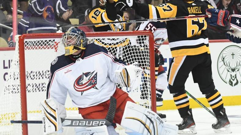 Sep 25, 2022; Pittsburgh, Pennsylvania, USA;  Pittsburgh Penguins forward Jason Zucker (16) celebrates his overtime goal by Columbus Blue Jackets goalie Nolan Lalonde (95) at PPG Paints Arena. Mandatory Credit: Philip G. Pavely-USA TODAY Sports