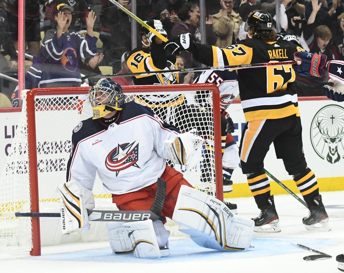 Sep 25, 2022; Pittsburgh, Pennsylvania, USA;  Pittsburgh Penguins forward Jason Zucker (16) celebrates his overtime goal by Columbus Blue Jackets goalie Nolan Lalonde (95) at PPG Paints Arena. Mandatory Credit: Philip G. Pavely-USA TODAY Sports