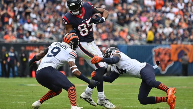 Sep 25, 2022; Chicago, Illinois, USA; Houston Texans tight end Pharaoh Brown (85) is brought down in the first quarter Chicago Bears defensive back Jaquan Brisker (9) and defensive back Eddie Jackson (4) after catching a pass at Soldier Field. Mandatory Credit: Jamie Sabau-USA TODAY Sports