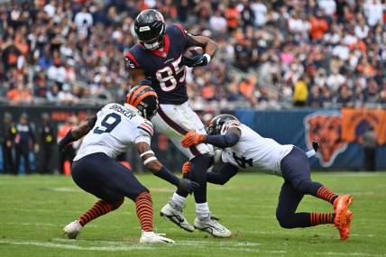 Sep 25, 2022; Chicago, Illinois, USA; Houston Texans tight end Pharaoh Brown (85) is brought down in the first quarter Chicago Bears defensive back Jaquan Brisker (9) and defensive back Eddie Jackson (4) after catching a pass at Soldier Field. Mandatory Credit: Jamie Sabau-USA TODAY Sports