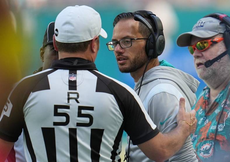 Miami Dolphins head coach Mike McDaniel talks with referee Alex Kemp (55) during the first half of an NFL game at Hard Rock Stadium in Miami Gardens, Sept. 25, 2022.
