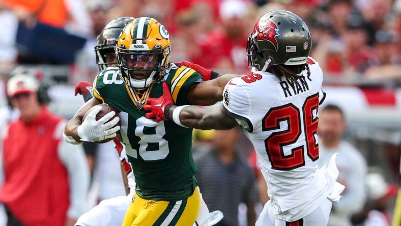 Sep 25, 2022; Tampa, Florida, USA;  Green Bay Packers wide receiver Randall Cobb (18) stiff arms Tampa Bay Buccaneers safety Logan Ryan (26) in the second quarter at Raymond James Stadium. Mandatory Credit: Nathan Ray Seebeck-USA TODAY Sports