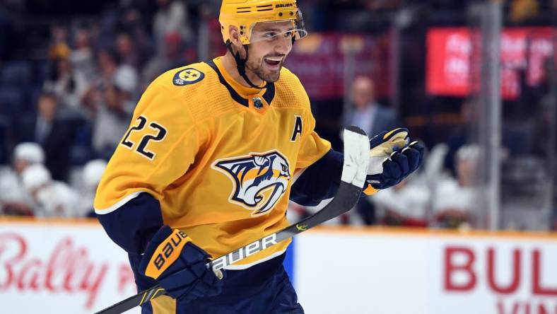 Sep 26, 2022; Nashville, Tennessee, USA; Nashville Predators right wing Nino Niederreiter (22) celebrates after assisting on a goal during the third period against the Florida Panthers at Bridgestone Arena. Mandatory Credit: Christopher Hanewinckel-USA TODAY Sports