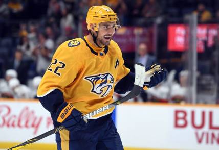 Sep 26, 2022; Nashville, Tennessee, USA; Nashville Predators right wing Nino Niederreiter (22) celebrates after assisting on a goal during the third period against the Florida Panthers at Bridgestone Arena. Mandatory Credit: Christopher Hanewinckel-USA TODAY Sports
