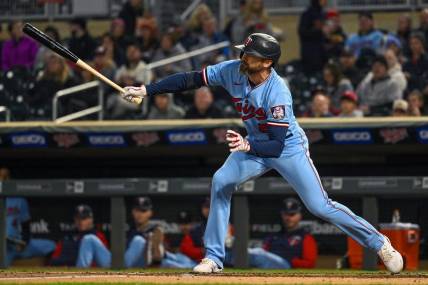 Sep 27, 2022; Minneapolis, Minnesota, USA;  Minnesota Twins infielder Jake Cave (8) hits a RBI single against the Chicago White Sox during the second inning at Target Field. Mandatory Credit: Nick Wosika-USA TODAY Sports