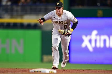 Sep 27, 2022; Pittsburgh, Pennsylvania, USA; Pittsburgh Pirates catcher Zack Collins (6) runs to first base for the force out during the third inning against the Cincinnati Reds at PNC Park. Mandatory Credit: David Dermer-USA TODAY Sports