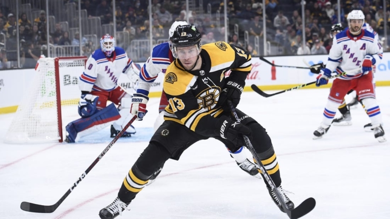 Sep 27, 2022; Boston, Massachusetts, USA;  Boston Bruins center Charlie Coyle (13) chases the puck along the boards during the third period against the New York Rangers at TD Garden. Mandatory Credit: Bob DeChiara-USA TODAY Sports