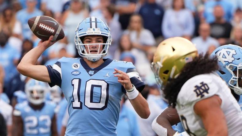 Sep 24, 2022; Chapel Hill, North Carolina, USA; North Carolina Tar Heels quarterback Drake Maye (10) looks to pass Notre Dame Fighting Irish linebacker Marist Liufau (8) pressures in the second quarter at Kenan Memorial Stadium. Mandatory Credit: Bob Donnan-USA TODAY Sports