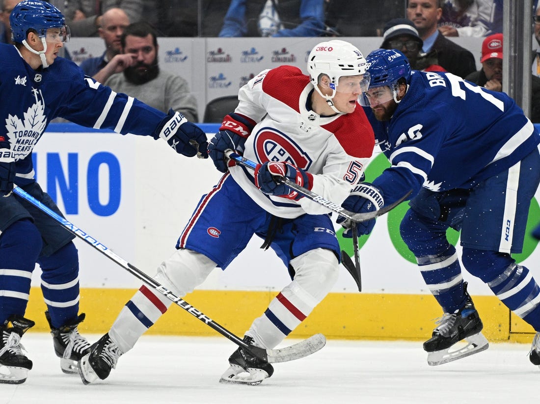 Sep 28, 2022; Toronto, Ontario, CAN; Montreal Canadiens forward Emil Heineman (51) moves past Toronto Maple Leafs defenseman TJ Brodie (78) in the third period at Scotiabank Arena. Mandatory Credit: Dan Hamilton-USA TODAY Sports