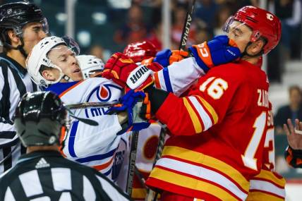 Sep 28, 2022; Calgary, Alberta, CAN; Edmonton Oilers left wing Tyler Benson (16) and Calgary Flames defenseman Nikita Zadorov (16) get into a scrum during the second period at Scotiabank Saddledome. Mandatory Credit: Sergei Belski-USA TODAY Sports