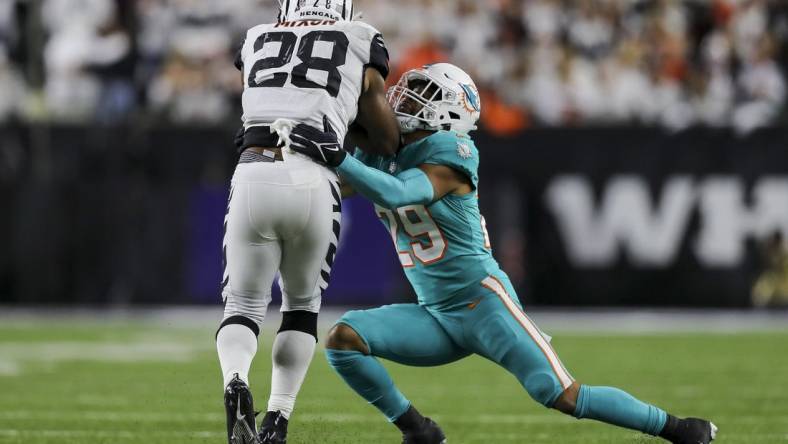 Sep 29, 2022; Cincinnati, Ohio, USA; Cincinnati Bengals running back Joe Mixon (28) runs with the ball against Miami Dolphins safety Brandon Jones (29) in the first half at Paycor Stadium. Mandatory Credit: Katie Stratman-USA TODAY Sports